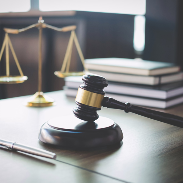 gavel, scale, pen, and stack of books
