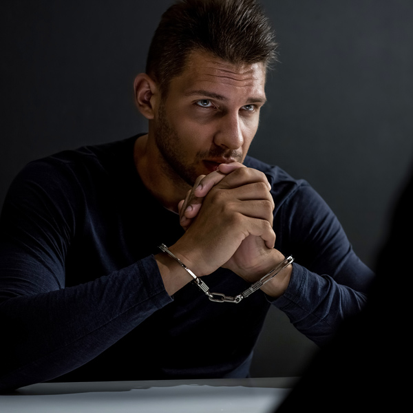 man in handcuffs with concerned look on face